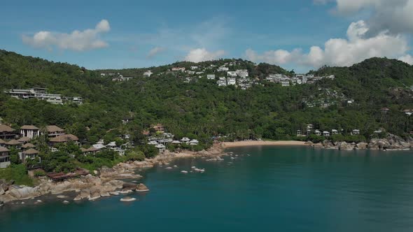 Luxury Resorts on the Hill with Turquoise Water Beautiful Rocks and Beach alt