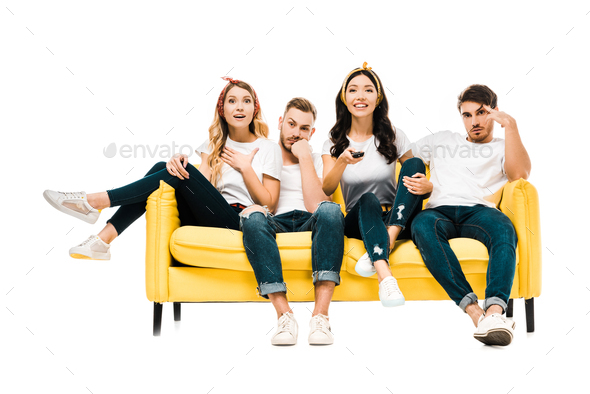 bored young men and happy women sitting on couch with remote controller and watching tv isolated on