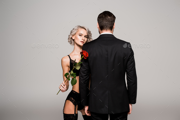 sexy woman in red bra and panties hugging handsome man isolated on black  Stock Photo by LightFieldStudios