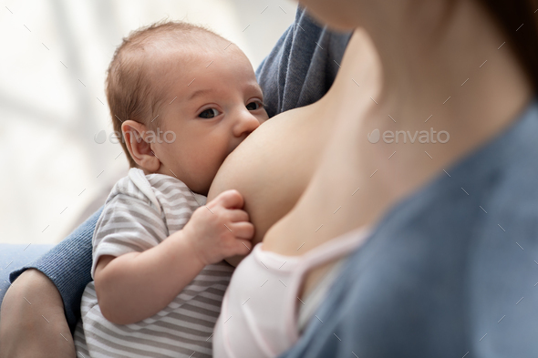 Closeup Shot Of Adorable Little Newborn Baby Suckling Milk From Mother's Breast - Stock Photo - Images
