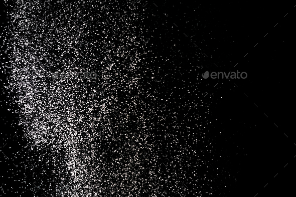 Flour sifting on a black background. White powder splash isolated on black background