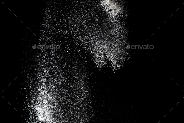 White powder splash isolated on black background. Flour sifting on a black background