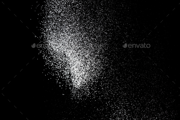 White powder splash isolated on black background. Flour sifting on a black background