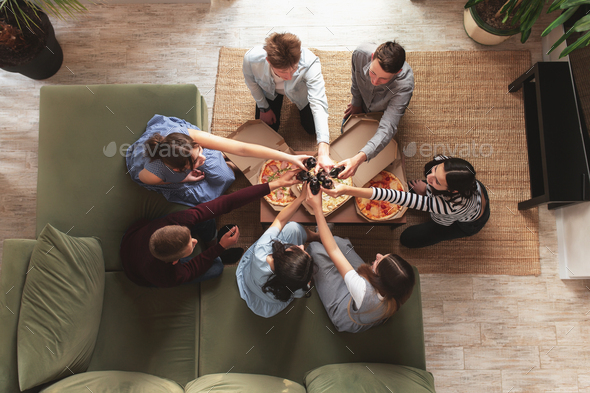 Pizza party, group of friends chatting, eating pizza, drinking sweet soda water - Stock Photo - Images