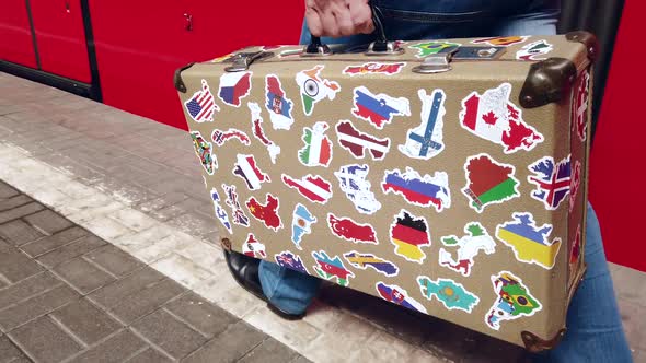 Passenger Is on the Platform of the Station with a Suitcase with Stickers From Different Countries