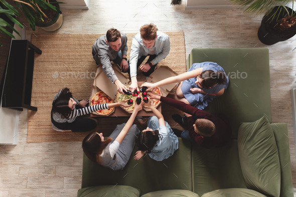Pizza party, group of friends chatting, eating pizza, drinking sweet soda water - Stock Photo - Images