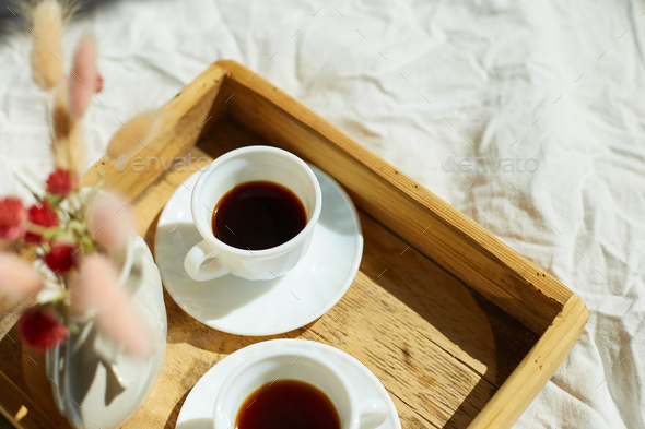 Breakfast in bed, try with two cups coffee and flower in sunlight at home - Stock Photo - Images