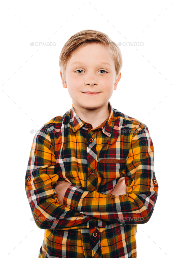 portrait of cute little boy standing with crossed arms and smiling at ...