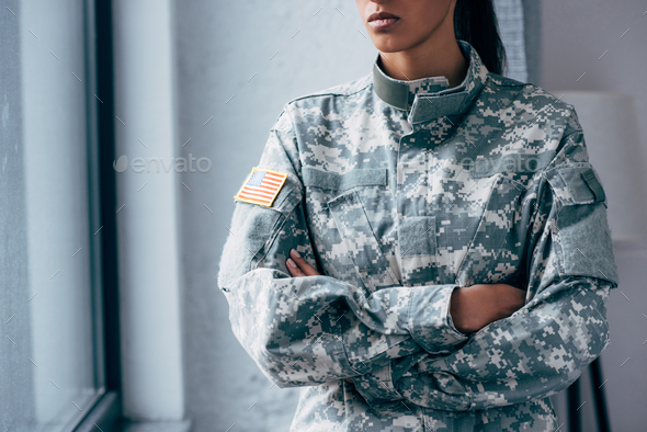 cropped view of african american female soldier in military uniform with usa flag emblem