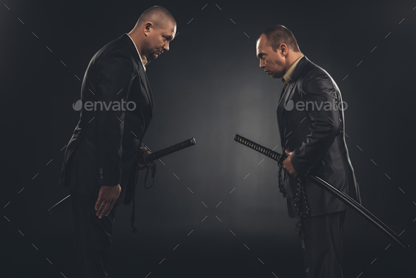 side view of modern samurai in suits bowing to each other isolated on ...