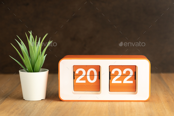Flip clock with 2022 number on wooden table