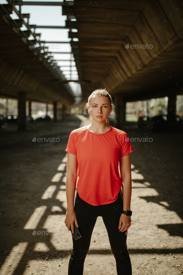 Be motivated! Beautiful sexy fitness woman wearing sportswear posing under the bridge. - Stock Photo - Images