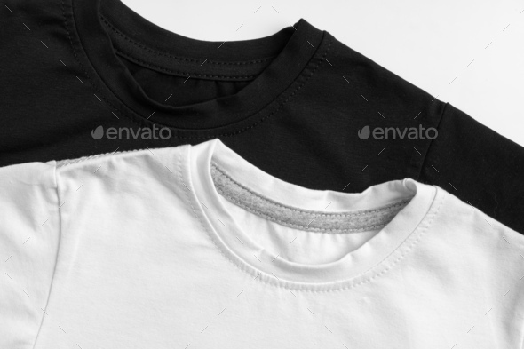 Row of white t-shirts on hangers on rack Stock Photo by FabrikaPhoto