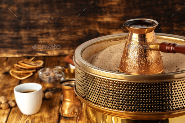 Turkish coffee in cezve on the sand - Stock Photo - Images