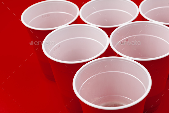 Red plastic cups and ball for game of beer pong Stock Photo by