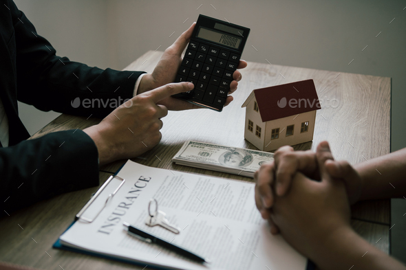Agents are calculating the loan payment rate or the amount of insurance premiums for customers