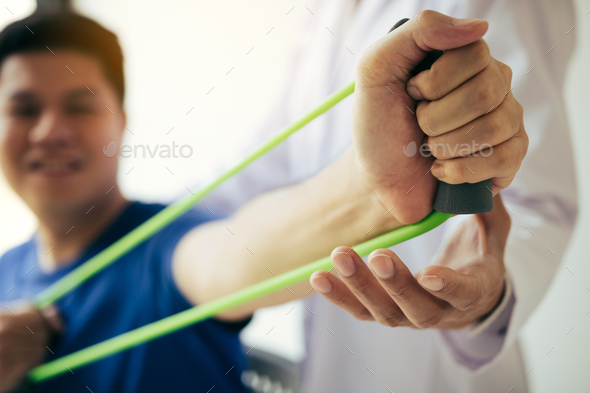 hand patient doing stretching exercise with a flexible exercise - Stock Photo - Images