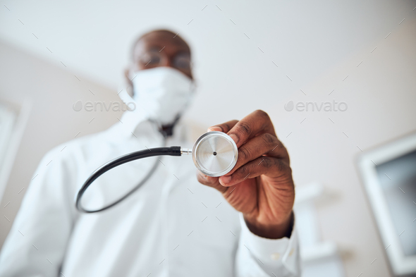 Chest-piece of stethoscope in a doctor hand