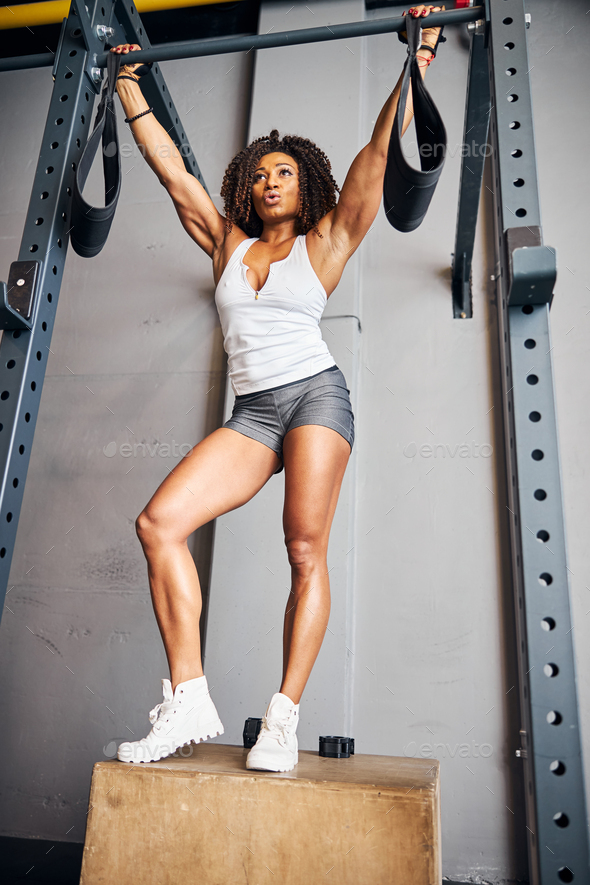 Fit woman preparing for the pull-ups on the horizontal bar Stock Photo by  Iakobchuk