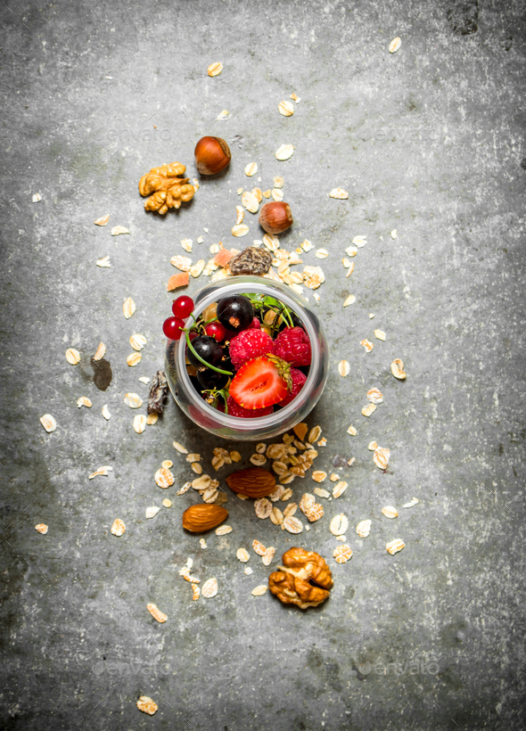 Fitness food. Berries with muesli and nuts.