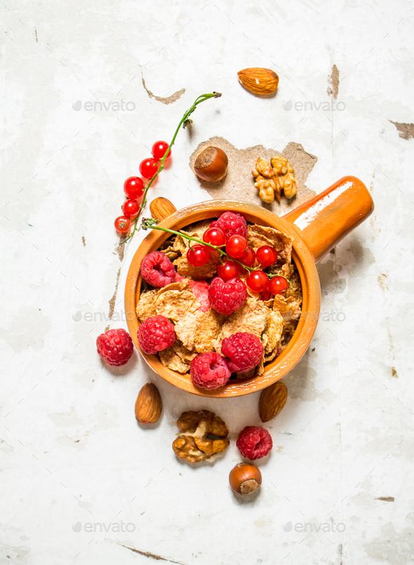 Fitness food. Muesli with ripe raspberries and nuts.