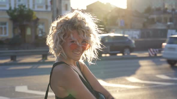 Smiley blonde woman looking at the camera.