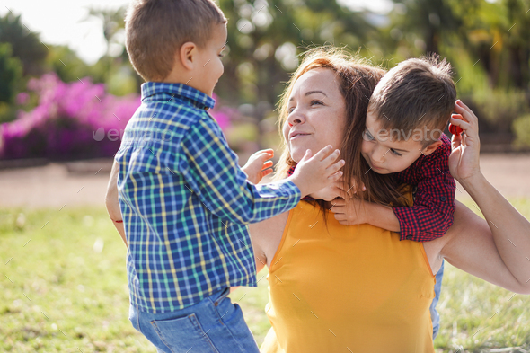 Mother have playful time with twin sons in nature park - Family, single ...