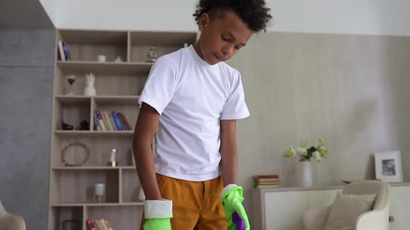 Young Guy Teenager Doing Chores Sweeping Floor in Living Room alt