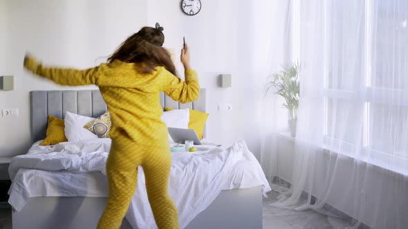 Excited Woman Dancing Near Bed After Waking Up