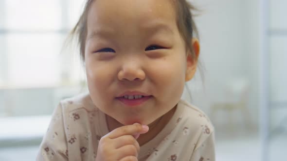 Portrait of Happy Asian Toddler Girl in Medical Office alt