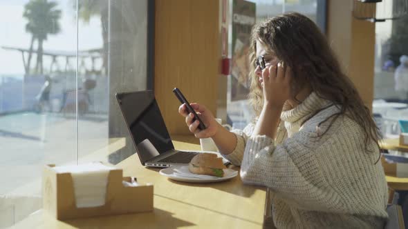 Lady at Desk in Cafe Relax with Smartphone