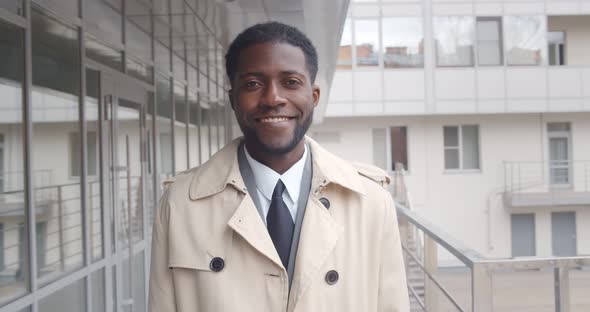 Portrait of Handsome African Businessman Smiling Outdoors Office Building alt