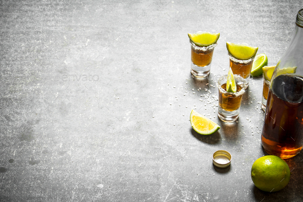 bottle of tequila with lime and salt. - Stock Photo - Images