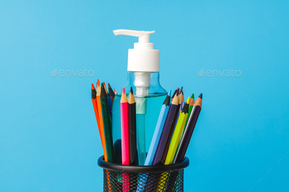 School supplies and hand sanitizer. Pandemic education concept