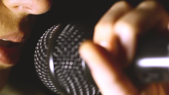 Woman singing to a microphone