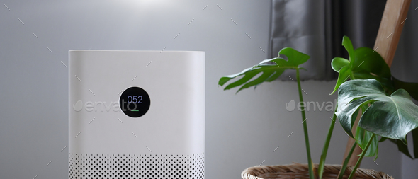 Air purifier with digital monitor screen in bedroom for show air quality and air pollution levels.