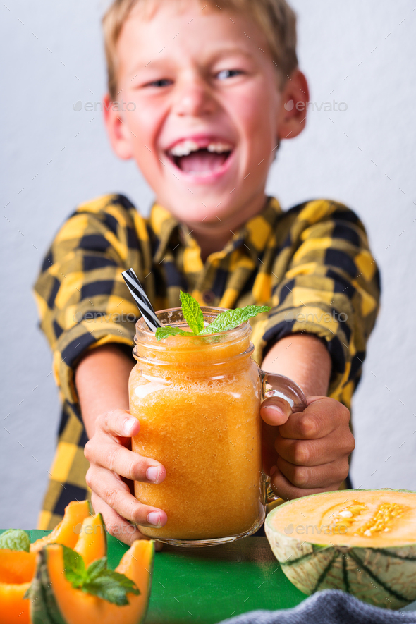 Happy boy drinking healthy smoothie with straw, enjoying and smiling Stock  Photo by antoninavlasova