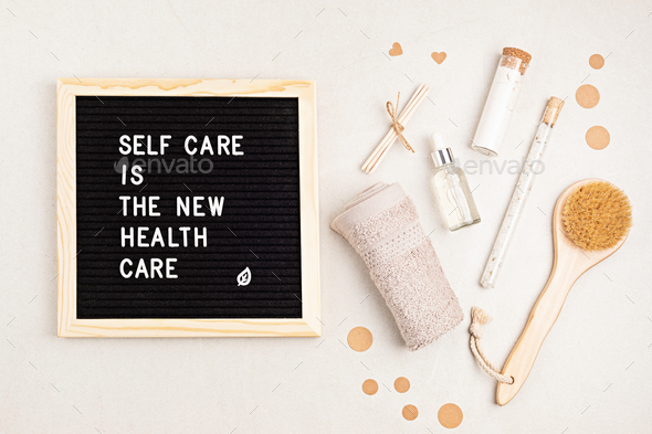 Self care is the new health care. Motivational quote on black letter board with variety of organic