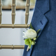 boutonnière on grooms jacket hanging over a chair at wedding - PhotoDune Item for Sale