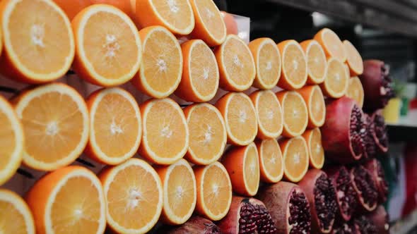 Sliced oranges and pomegranate fruits in the stall market in Tel Aviv, Israel alt