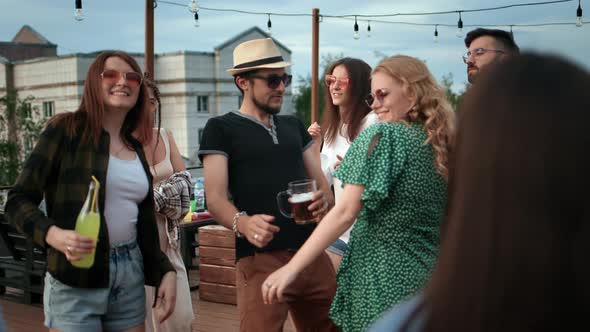 Fashion Couple with Alcohol Dancing at Night Roof Party Enjoy Audio Sound People Crowd Slow Motion alt