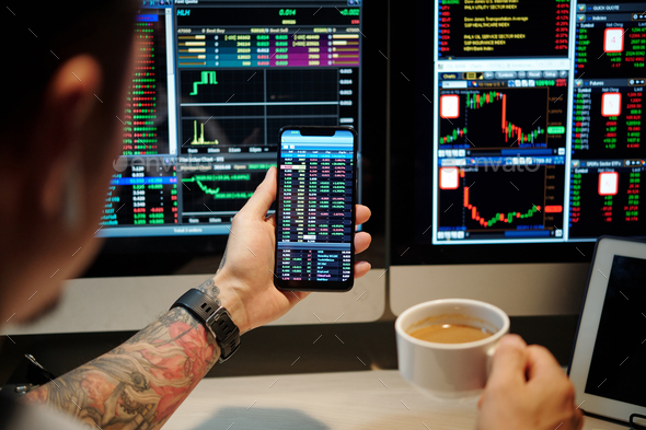 Trader Checking Shares Prices via App - Stock Photo - Images