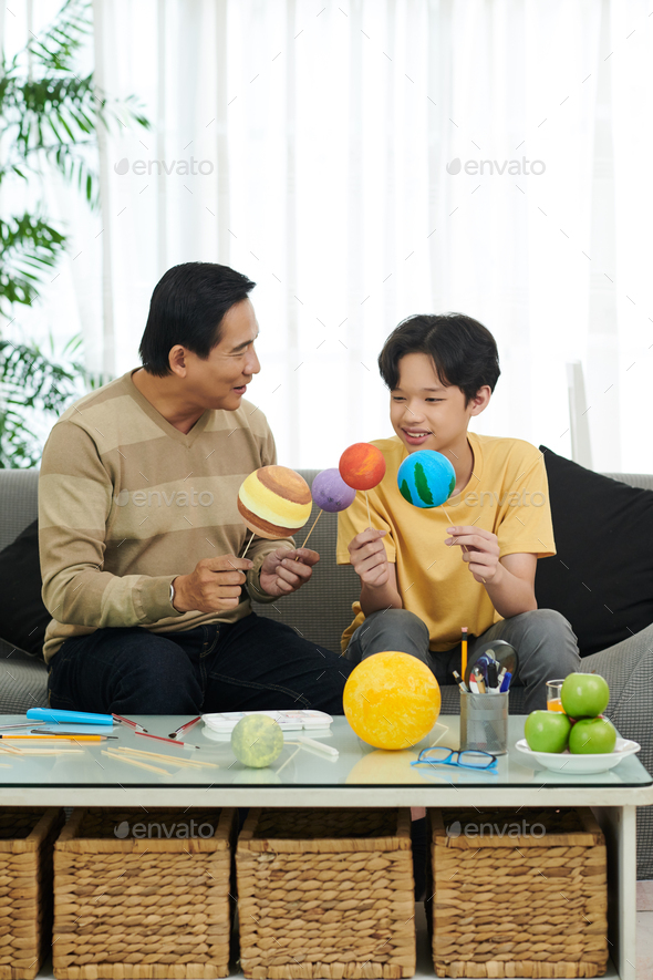 Father and Son Finishing Solar System Model