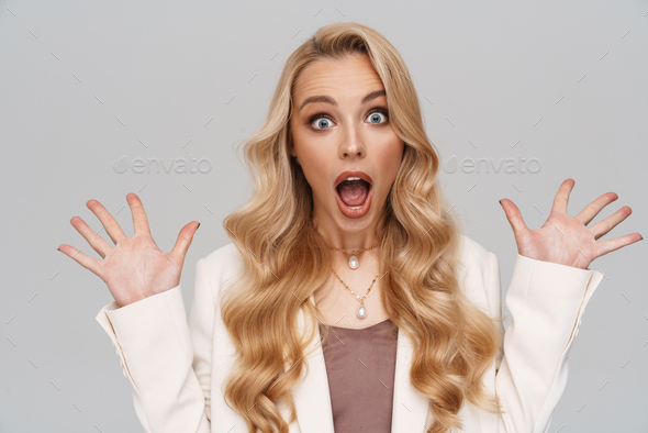 Beautiful shocked girl in jacket expressing surprise on camera Stock ...