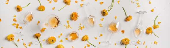 Trendy Orange or Amber wine and yellow flowers, wide composition - Stock Photo - Images