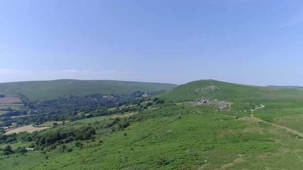 Bonehill Rocks, Wide shot aerial tracking forward over the wide expanse of Dartmoor, tors, grassy mo alt