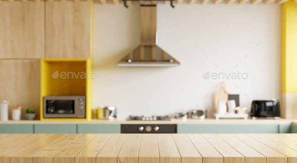 Empty wooden table and blurred kitchen yellow wall background. Stock Photo  by vanitjan