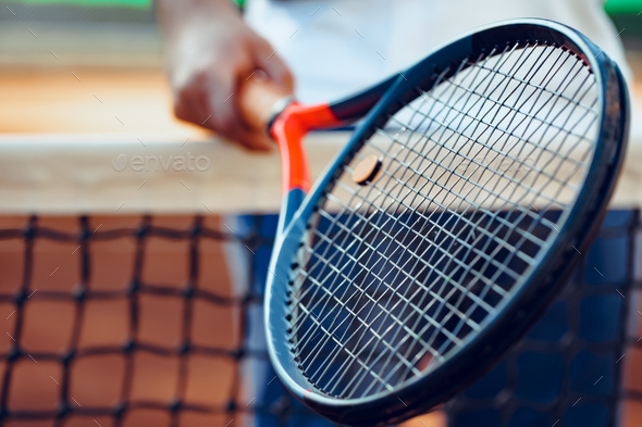 Tennis racket and tennis net on tennis court - Stock Photo - Images