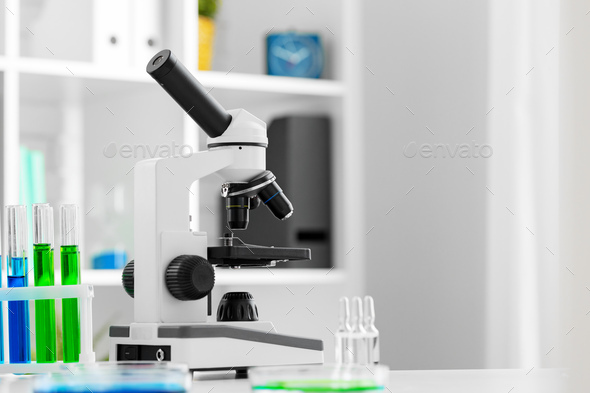 Scientific healthcare research background with microscope in medical  laboratory Stock Photo by FabrikaPhoto