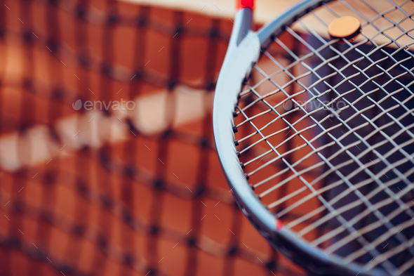 Tennis racket and tennis net on tennis court - Stock Photo - Images